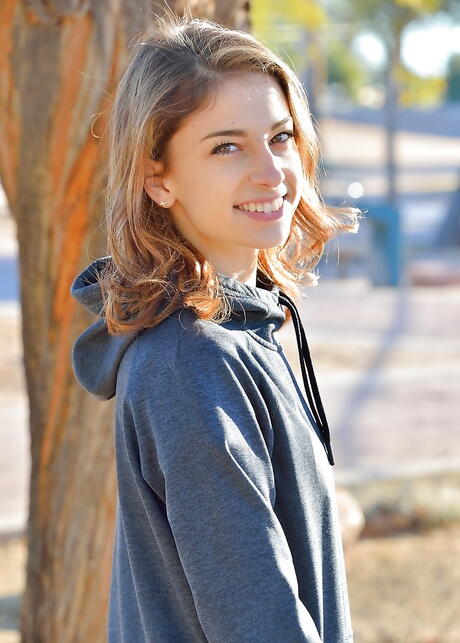 Shapely american red-haired youthful Kristen Scott in fancy skirt denudes tiny tits and hairy pussy outdoor